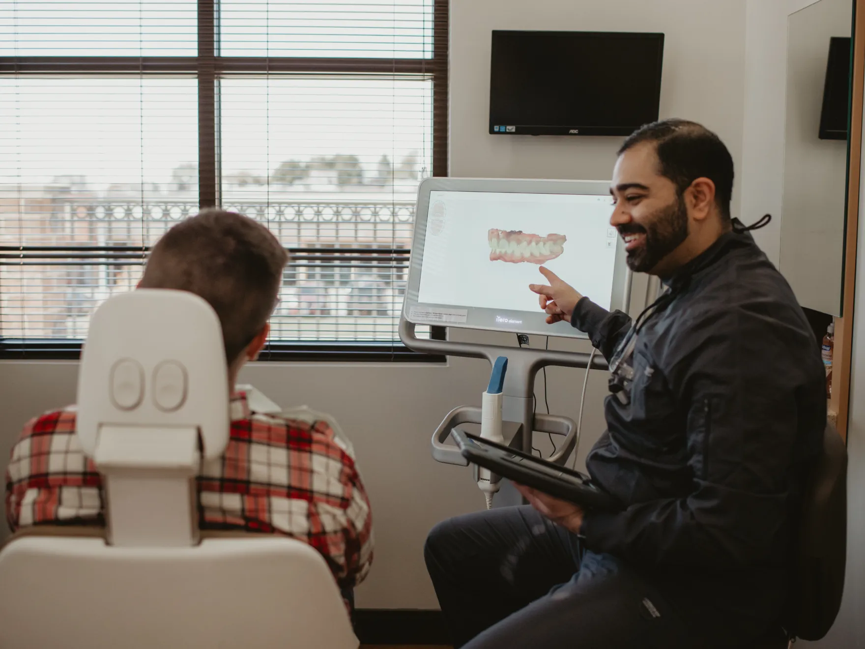 Dr. Patel showing patient a model of his teeth