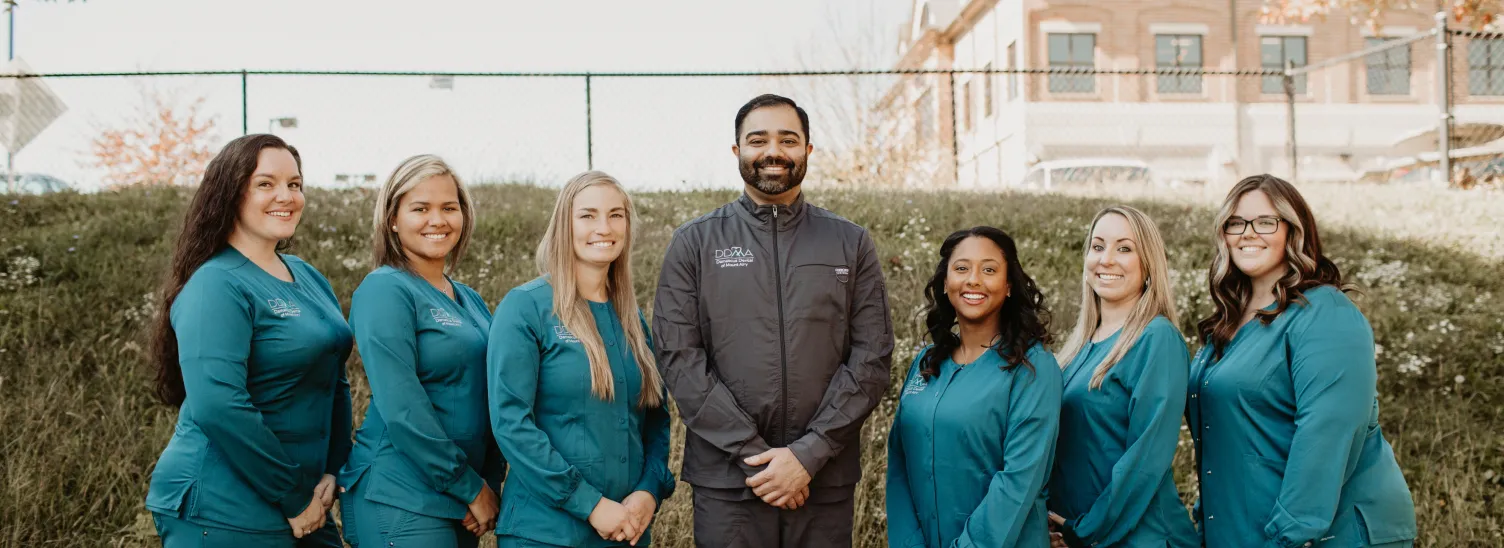 Dr. Patel and team smiling and posing together